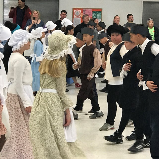 During Colonial Day, the fifth grade students learn a variety of dances which they perform for the parents.