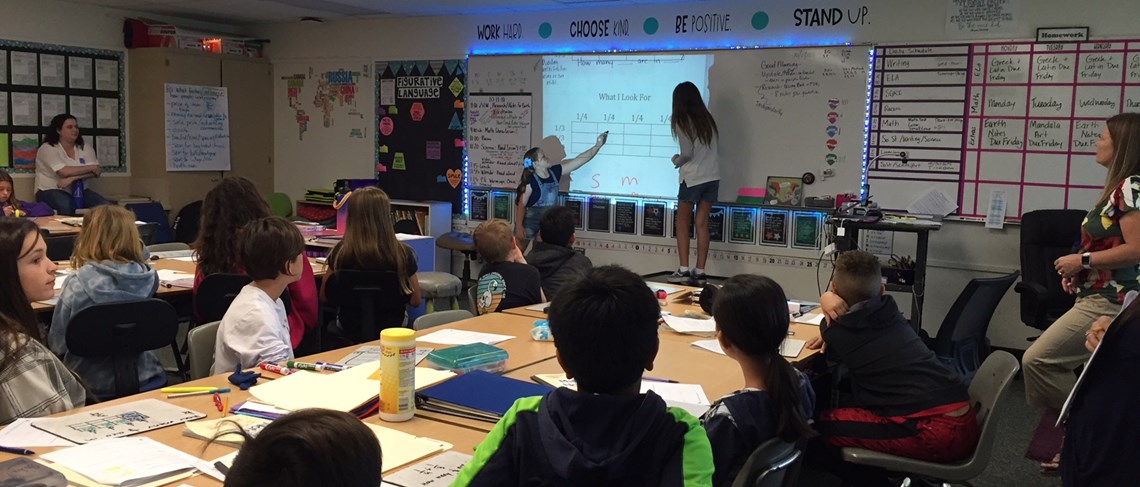 Students demonstrate solving a math problem