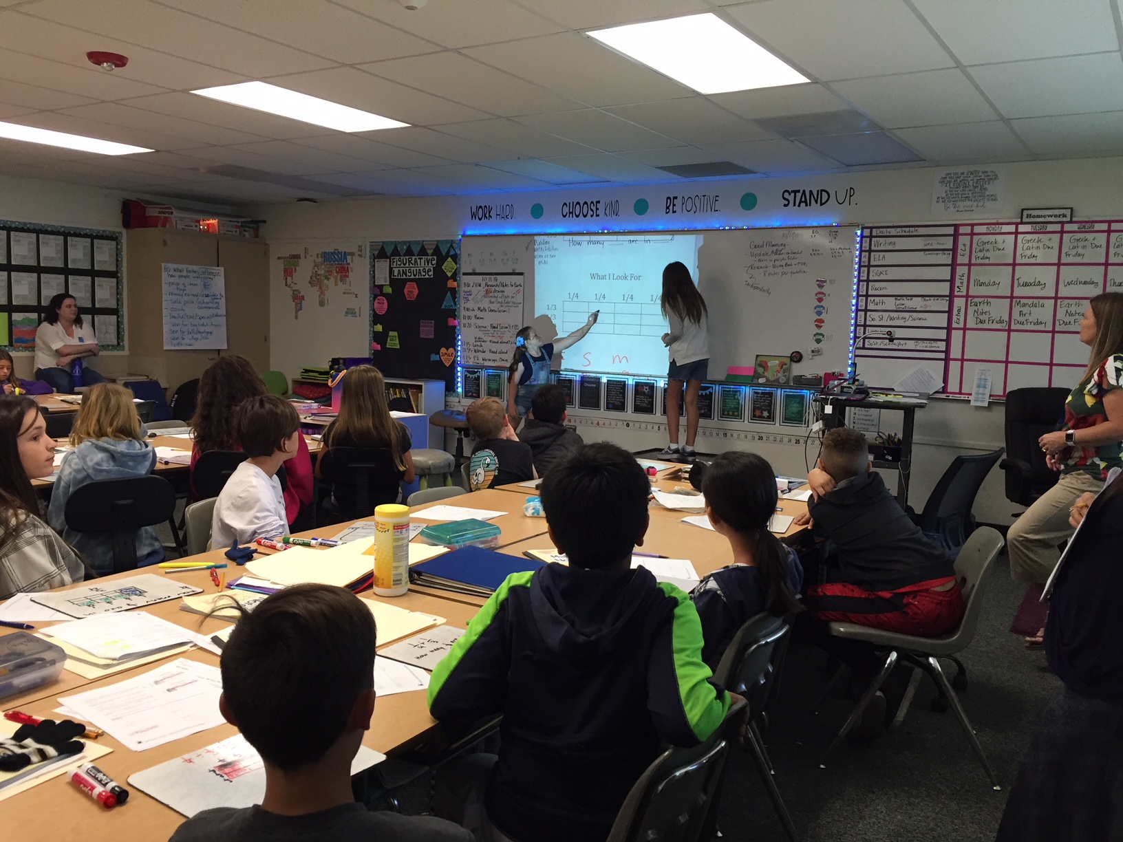 Students demonstrate solving a math problem